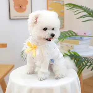 Détail du pull tricoté pour animaux avec bavoir en tulle coloré et nœud jaune