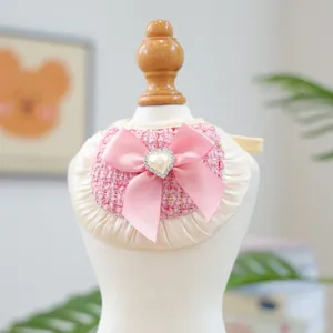 Pink tweed pet bandana with cream lace trim and a heart-shaped pearl bow for small dogs