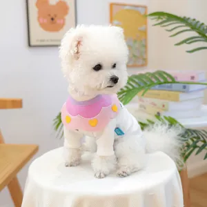 Close-up of pink and purple petal-edged dog bib with yellow heart on white ribbed shirt