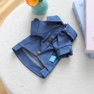 Close-up of dark blue pet denim shirt with gold stitching and snap button details