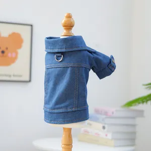 Detail of dark blue denim dog jacket with metal D-ring for leash attachment