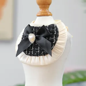 Detail of luxury dog bandana with cream ruffles, black tweed and a heart pearl bow