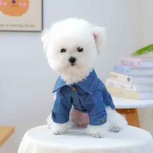 Detail of a dark blue denim pet jacket with metal buttons and classic collar design