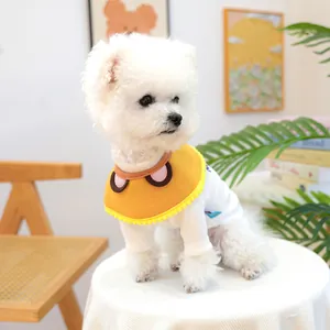Detail of cute yellow cartoon bib with ears paired with a white ribbed cotton pet t-shirt
