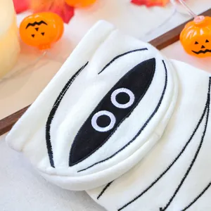 Close-up of white knit pet mummy sweater with embroidery for Halloween party