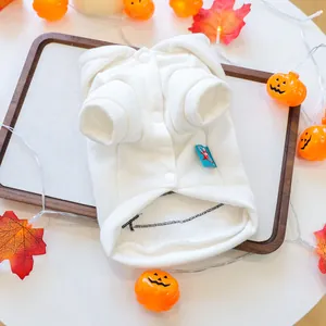 White fleece pet hoodie with snap buttons shown in a festive Halloween setting