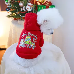 Detail of red Christmas pet hoodie with festive tree and snowflake patterns on soft fleece