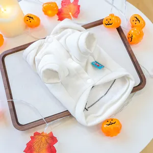 Detail of white fleece pet hoodie with snap buttons in a festive Halloween setting
