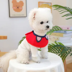 Close-up of white ribbed pet sweater with red and blue wavy knit collar and pink dots