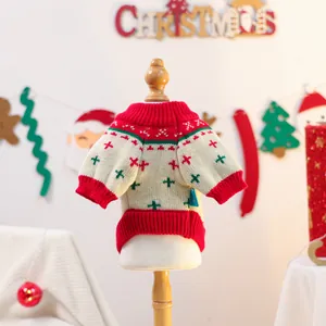 Detailed view of white knitted Christmas pet sweater with red and green festive patterns
