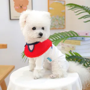 Detail of red pet bib with cute ear design and wavy trim on a white knit dog shirt