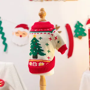 Macro detail of Christmas tree knit pattern on cream pet sweater with red ribbed edges
