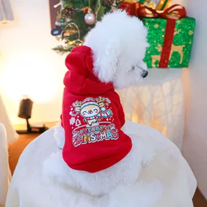 Detail of red Christmas pet hoodie with reindeer print on a white dog in a cozy setting