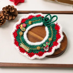 Detail of Christmas dog scarf with crochet wave pattern, mini stocking and metal pet tag