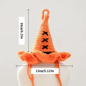 Detail of hand-crocheted orange wizard hat for pets showing 16x13cm sizing and knit texture