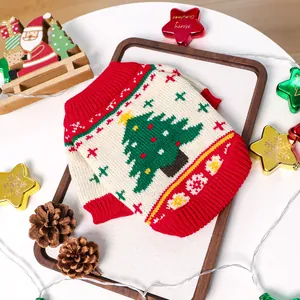Detail of red Christmas pet sweater with knitted xmas tree pattern and festive ornaments