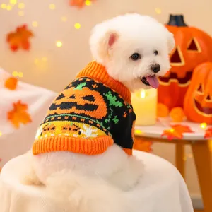Detailed knit texture of Halloween pet sweater featuring orange pumpkin face and green leaf motifs