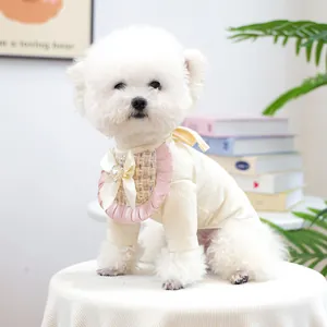 Detail of knit dog sweater with pink plaid ruffle bib and heart metal pendant