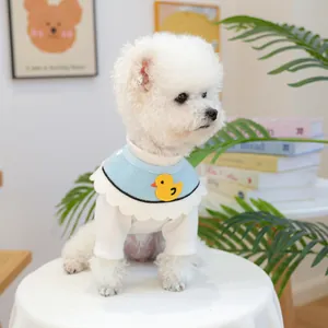 Detail of light blue pet bib with duck patch and white ribbed undershirt for small dogs