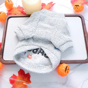 Detail view of gray knit pet sweater featuring embroidered BOO text and pumpkin motifs