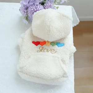 Detailed macro view of white sherpa fleece pet hoodie with rainbow heart and Love embroidery