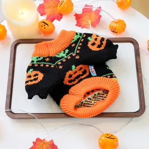 Detail of a Halloween pet sweater featuring orange pumpkin patterns and knitted texture