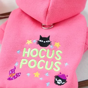 Close-up of pink pet hoodie with Halloween embroidery and metal D-ring attachment