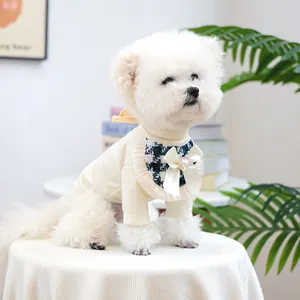 Detail of blue plaid pet bib with silk bow, heart rhinestone, and ruffled edges