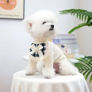 Detail of tweed collar with silk bow and heart pearl button on pet sweatshirt