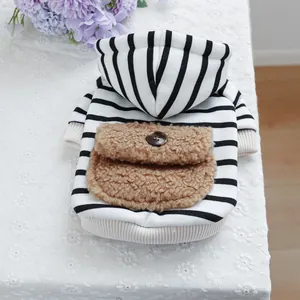 Close-up of pet hoodie with black and white stripes and brown plush pocket detail