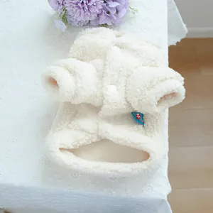 Detail of white sherpa fleece pet jacket featuring soft texture and front button closure