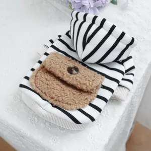 Detail of pet hoodie featuring black and white stripes and a brown fleece pocket with button