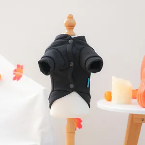 Detail of pet hoodie showing matte snap buttons and soft knit fabric on a model