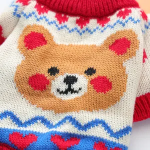 Detailed view of soft knit pet sweater with brown bear head and red heart patterns