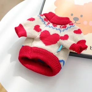 Detail of pet knit sweater with red heart patterns and ribbed neck for cats and small dogs