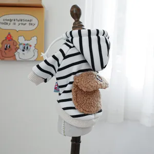 Detail of pet hoodie featuring black and white stripes and a brown sherpa bear pocket