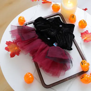 Detail van Halloween-huisdierjurk met zwart fluwelen top en bordeauxrode rok van gaas