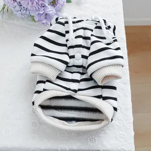 Detail of pet striped hoodie with snaps and ribbed cuffs on white lace background