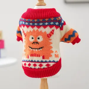 Close-up of knit texture and cute orange monster pattern on pet sweater