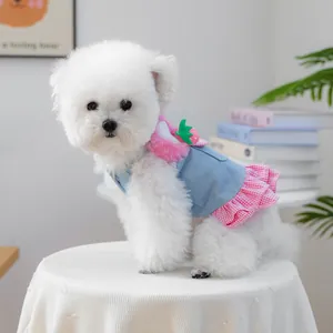 Detail of strawberry denim dog dress with pink plaid ruffles and soft plush trim