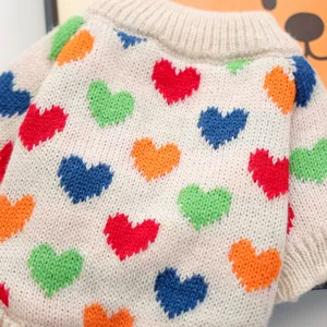 Close-up of knit pet sweater with colorful heart jacquard and ribbed neckline detail