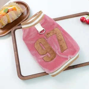 Close-up of pink velvet pet vest featuring number 97 embroidery and metal D-ring attachment