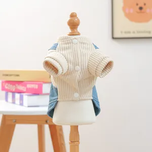 Detail van gebreid huisdiervest met beige ribstof, blauwe denim patchwork en knoopjes