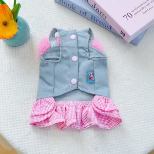 Detail of blue denim pet dress with pink plush collar and checkered ruffle skirt