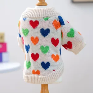 Detail of soft knit pet sweater with colorful heart patterns and ribbed edge craftsmanship