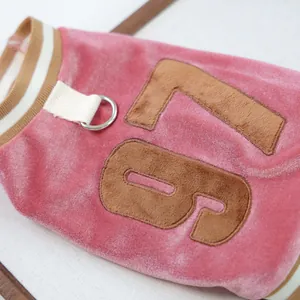 Detail of pink velvet pet vest with metallic D-ring for leash and brown 79 embroidery