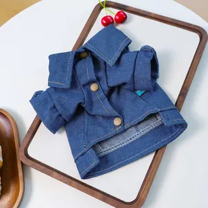 Detail of blue denim pet jacket showing classic collar, stitching, and button accents