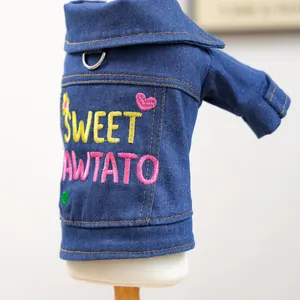 Detail of blue denim pet jacket with Sweet Pawtato embroidery and metal D-ring attachment