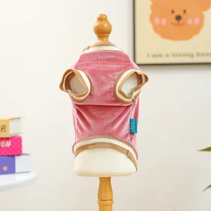 Close-up of pink velvet pet sweater with striped ribbing and Petcircle brand label