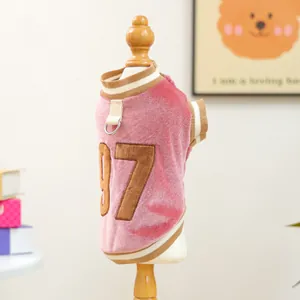 Detailed macro view of pink velvet pet jersey with number 97 embroidery and metal D-ring